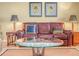 A well-decorated living room with a leather sofa and accent pillows at 5268 Pebble Beach Blvd, Winter Haven, FL 33884