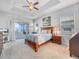 Tranquil main bedroom with a ceiling fan and a view of the lanai at 5268 Pebble Beach Blvd, Winter Haven, FL 33884
