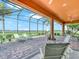 Screened patio with brick pavers, seating and peaceful golf course and lake views at 5268 Pebble Beach Blvd, Winter Haven, FL 33884