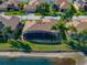 Backyard of single-Gathering home with screened in patio overlooking serene pond at 5357 Hogan Ln, Winter Haven, FL 33884