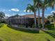 Beautiful backyard with lush lawn, mature palm trees, and a screened lanai at 5357 Hogan Ln, Winter Haven, FL 33884