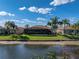 A serene backyard with lake view, lush lawn, and a screened lanai at 5357 Hogan Ln, Winter Haven, FL 33884