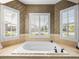 Bathroom features a large soaking tub and tiled surround with exterior views at 5357 Hogan Ln, Winter Haven, FL 33884
