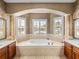 Bathroom features a large tub with jets and decorative tile surround at 5357 Hogan Ln, Winter Haven, FL 33884