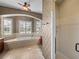 Bathroom with soaking tub, tiled shower and dual windows at 5357 Hogan Ln, Winter Haven, FL 33884