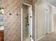 Tiled walk-in shower in bathroom with tile accent walls and a glass door at 5357 Hogan Ln, Winter Haven, FL 33884