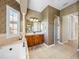 Bathroom featuring a soaking tub, vanity with dark wood cabinets, and a separate shower at 5357 Hogan Ln, Winter Haven, FL 33884