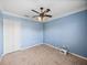 Bedroom features tile floors, ceiling fan, and closet providing ample storage at 5357 Hogan Ln, Winter Haven, FL 33884