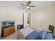 Comfortable bedroom with tile flooring, ceiling fan and television at 5357 Hogan Ln, Winter Haven, FL 33884