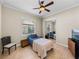 Cozy bedroom features tile floors, ceiling fan, and mirrored closet doors at 5357 Hogan Ln, Winter Haven, FL 33884