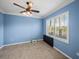 Bedroom featuring a ceiling fan, tile floors and a large window to let in lots of natural light at 5357 Hogan Ln, Winter Haven, FL 33884