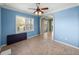 Bedroom featuring tile floors, ceiling fan, and an arched entry leading to an outdoor seating area at 5357 Hogan Ln, Winter Haven, FL 33884