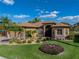 Beautiful home with a manicured lawn, stone accents, lush landscaping, and a paver driveway at 5357 Hogan Ln, Winter Haven, FL 33884