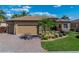 Charming home boasts a manicured lawn, brick driveway, and a two-car garage for a lovely curb appeal at 5357 Hogan Ln, Winter Haven, FL 33884