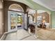 Elegant foyer with tile flooring, an arched doorway, and a view into a well-decorated living space at 5357 Hogan Ln, Winter Haven, FL 33884