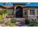 Inviting front entrance with stone accents, decorative glass doors, and a well-landscaped walkway at 5357 Hogan Ln, Winter Haven, FL 33884
