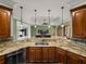 The kitchen has granite countertops and custom wood cabinets and connects to the living room at 5357 Hogan Ln, Winter Haven, FL 33884