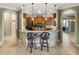 Elegant kitchen with granite countertops, tiled backsplash, pendant lighting, and bar seating at 5357 Hogan Ln, Winter Haven, FL 33884