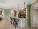 Open kitchen bar with modern pendant lighting, dark wood cabinets, and tiled floor at 5357 Hogan Ln, Winter Haven, FL 33884