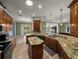 A kitchen island complements the granite countertops and wood cabinets at 5357 Hogan Ln, Winter Haven, FL 33884