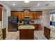 Beautiful kitchen with custom cabinets, granite countertops, stainless steel appliances, and a center island at 5357 Hogan Ln, Winter Haven, FL 33884