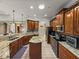 Spacious kitchen featuring wood cabinets, granite countertops and stainless steel appliances at 5357 Hogan Ln, Winter Haven, FL 33884