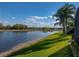 The peaceful lake provides a serene backdrop to the lush backyard at 5357 Hogan Ln, Winter Haven, FL 33884