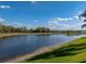 Backyard with lake view has tranquil waters and lush green lawn at 5357 Hogan Ln, Winter Haven, FL 33884