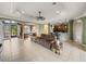 Open concept living room with tiled floors, neutral decor, and a ceiling fan at 5357 Hogan Ln, Winter Haven, FL 33884