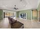 Relaxing living room with lake view, television, ceiling fan, and tiled floor at 5357 Hogan Ln, Winter Haven, FL 33884
