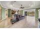 Spacious living room with tiled floors and sliding glass doors to the lake at 5357 Hogan Ln, Winter Haven, FL 33884