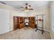Home office with built-in desk, ceiling fan, and space for exercise equipment at 5357 Hogan Ln, Winter Haven, FL 33884