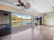 Enclosed patio boasts tile flooring, ceiling fan, and beautiful views of the lake at 5357 Hogan Ln, Winter Haven, FL 33884