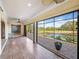 Enclosed patio boasts tile flooring, ceiling fan, and beautiful views of the lake at 5357 Hogan Ln, Winter Haven, FL 33884