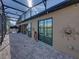 Screened in patio overlooking pond, featuring pavers, and access to the home's interior at 5357 Hogan Ln, Winter Haven, FL 33884
