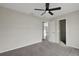 Carpeted bedroom featuring an open doorway to the living area and neutral walls and trim at 583 Drayton Rd, Winter Haven, FL 33884