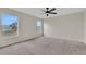 Bright carpeted bedroom featuring two windows and neutral paint and trim at 583 Drayton Rd, Winter Haven, FL 33884