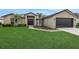 Charming single-story home with lush green lawn and attached two-car garage at 583 Drayton Rd, Winter Haven, FL 33884