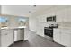 Bright kitchen features stainless steel appliances and white cabinets at 583 Drayton Rd, Winter Haven, FL 33884