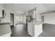 Bright kitchen with stainless steel appliances, white cabinets, and an island with a sink at 583 Drayton Rd, Winter Haven, FL 33884