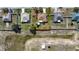 Aerial view of a property with a well-maintained lawn surrounded by neighboring houses and greenery at 625 Hatchwood Dr, Haines City, FL 33844