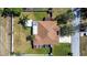 An aerial view of the well-maintained home featuring a lush green lawn and fenced in yard at 625 Hatchwood Dr, Haines City, FL 33844