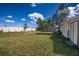 Expansive backyard with a white fence and a well-maintained lawn at 625 Hatchwood Dr, Haines City, FL 33844