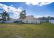 The backyard features a lawn and mature trees, offering a private outdoor space at 625 Hatchwood Dr, Haines City, FL 33844