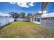 A spacious backyard has a white fence and shed, creating a comfortable outdoor space at 625 Hatchwood Dr, Haines City, FL 33844