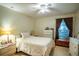 Inviting bedroom with ceiling fan, light walls, and cozy atmosphere at 625 Hatchwood Dr, Haines City, FL 33844