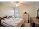 Bedroom showcasing neutral tones, ceiling fan, and a large window at 625 Hatchwood Dr, Haines City, FL 33844