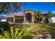Charming home featuring a stone facade, well-manicured lawn, and inviting curb appeal at 625 Hatchwood Dr, Haines City, FL 33844
