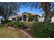 Well-maintained home with a stone facade, lush landscaping, and a welcoming entrance at 625 Hatchwood Dr, Haines City, FL 33844