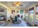 Bright Florida room with tile floors, ceiling fan, and large windows with views of the outdoors at 625 Hatchwood Dr, Haines City, FL 33844